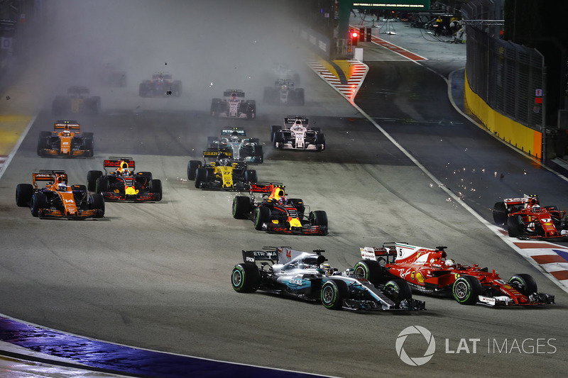 Sebastian Vettel, Ferrari SF70H, Max Verstappen, Red Bull Racing RB13, Kimi Raikkonen, Ferrari SF70H, collide at the start as Lewis Hamilton, Mercedes AMG F1 W08, finds his way through