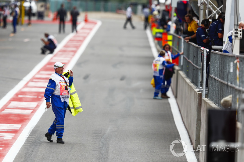 A Marshal in the pit lane