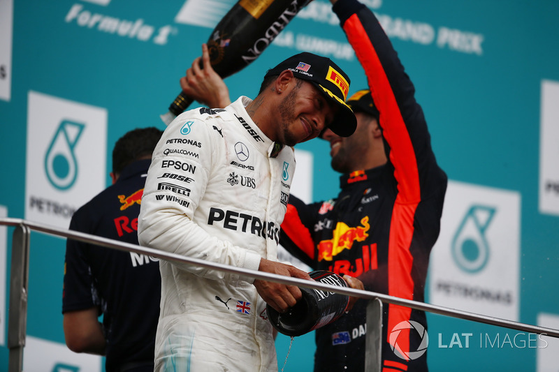 third place Daniel Ricciardo, Red Bull Racing, pours Champagne over second place Lewis Hamilton, Mercedes AMG F1, Max Verstappen, Red Bull Racing, race winner, on the podium