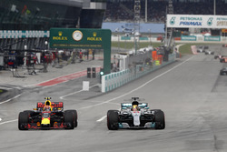Lewis Hamilton, Mercedes AMG F1 W08, battles, Max Verstappen, Red Bull Racing RB13, for the lead