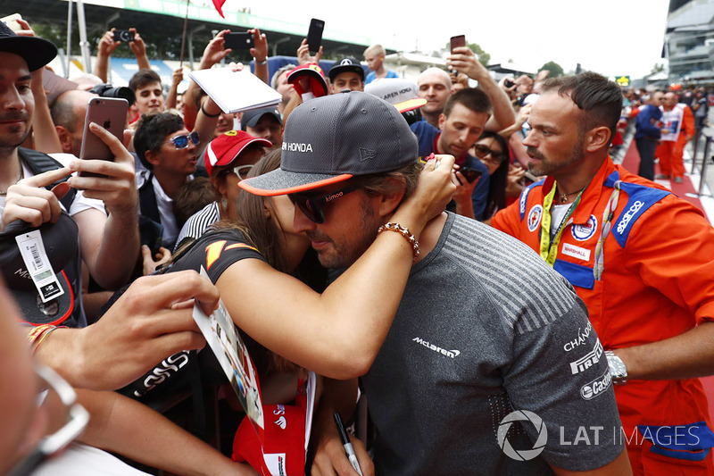 Fernando Alonso, McLaren, is greeted by a friendly fan