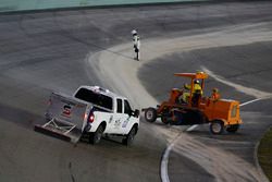 Track workers cleaning the track after the red flag