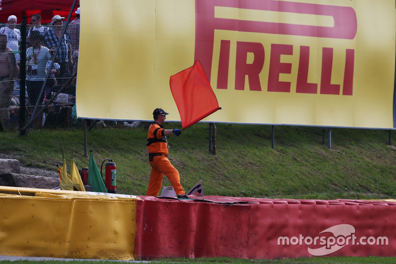 A marshal waves a red flag as the race is stoppd