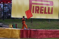 A marshal waves a red flag as the race is stoppd
