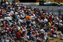 Valtteri Bottas, Williams FW38, passes crowd of fans di infield