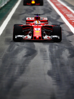 Sebastian Vettel, Ferrari SF70H, Max Verstappen, Red Bull Racing RB13, in the pits