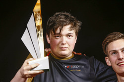 Brendon Leigh celebrates on the podium after winning the E-Sports event