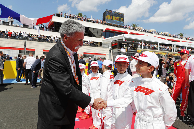 Chase Carey, Chairman, Formula One, meets the Grid Kid mascots