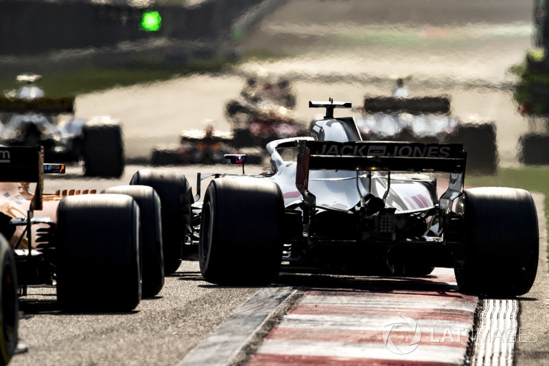 Romain Grosjean, Haas F1 Team VF-18 Ferrari, pulls across ahead of Fernando Alonso, McLaren MCL33 Renault