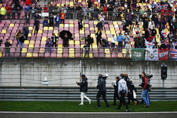 Lewis Hamilton, Mercedes AMG, gives caps to fans during a weather delay in FP2. World