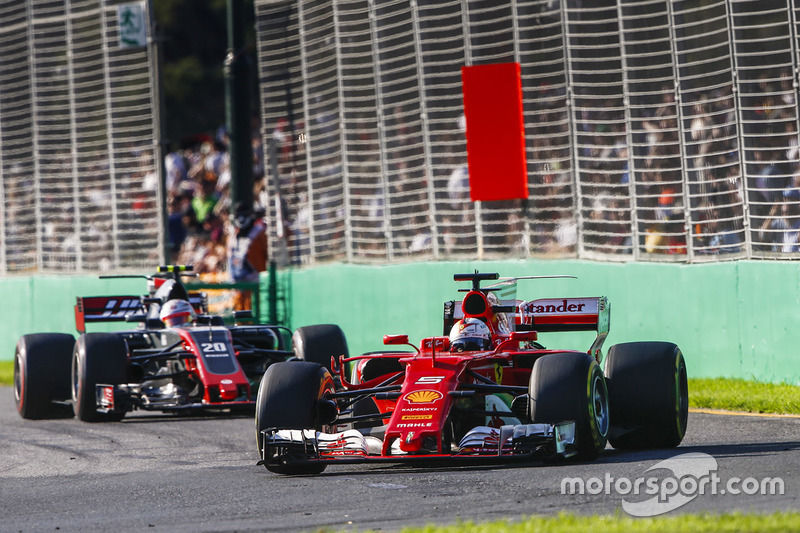 Sebastian Vettel, Ferrari SF70H, leads Kevin Magnussen, Haas F1 Team VF-17