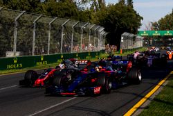 Carlos Sainz Jr., Scuderia Toro Rosso STR12, leads Romain Grosjean, Haas F1 Team VF-17