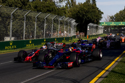 Carlos Sainz Jr., Scuderia Toro Rosso STR12, leads Romain Grosjean, Haas F1 Team VF-17