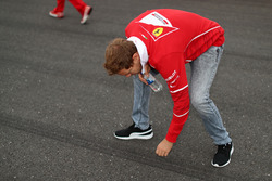 Sebastian Vettel, Ferrari walks the track and touches the asphalt