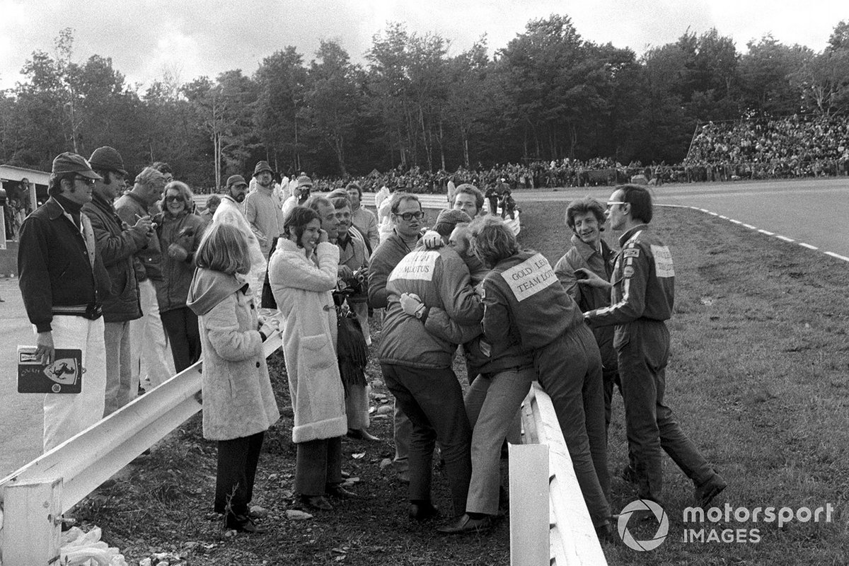Colin Chapman is embraced by his mechanics after Emerson Fittipaldi's win, ensuring the World Championship for Jochen Rindt