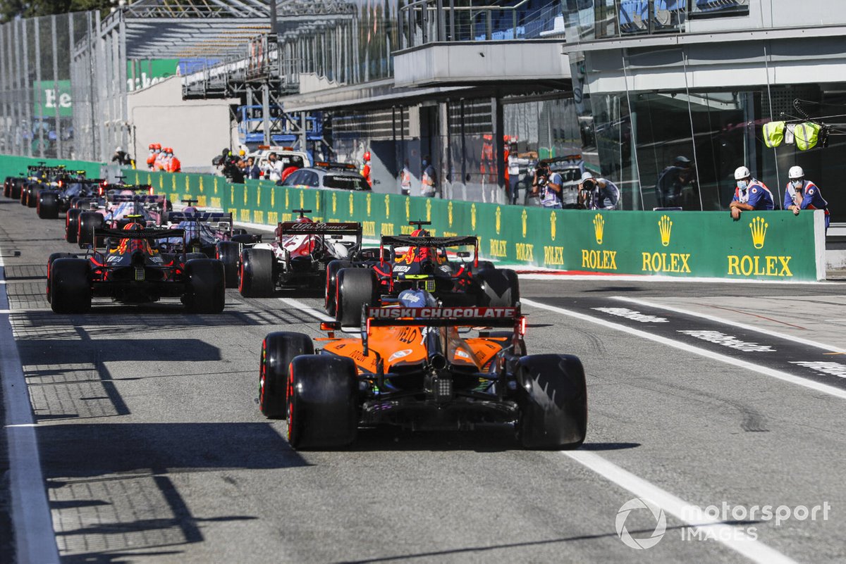 Alex Albon, Red Bull Racing RB16, Max Verstappen, Red Bull Racing RB16, and Lando Norris, McLaren MCL35, to the cicruit
