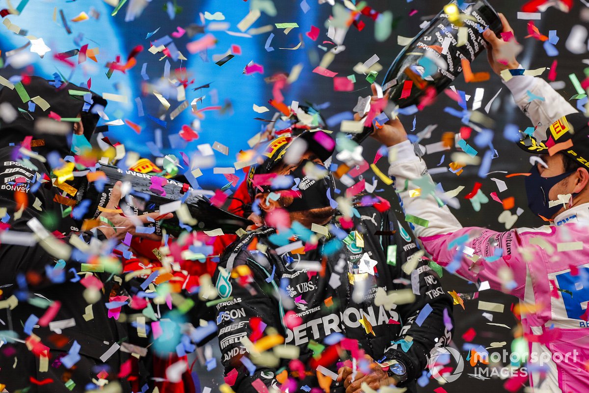 Sebastian Vettel, Ferrari, 3rd position, and Sergio Perez, Racing Point, 2nd position, pour Champagne over Lewis Hamilton, Mercedes-AMG F1, 1st position, on the podium