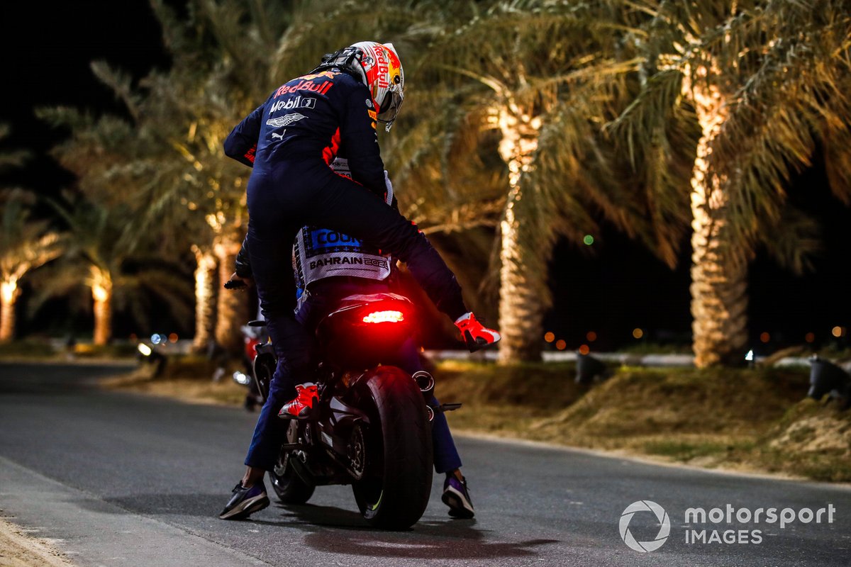 Max Verstappen, Red Bull Racing, gets on a course motorcycle after retiring