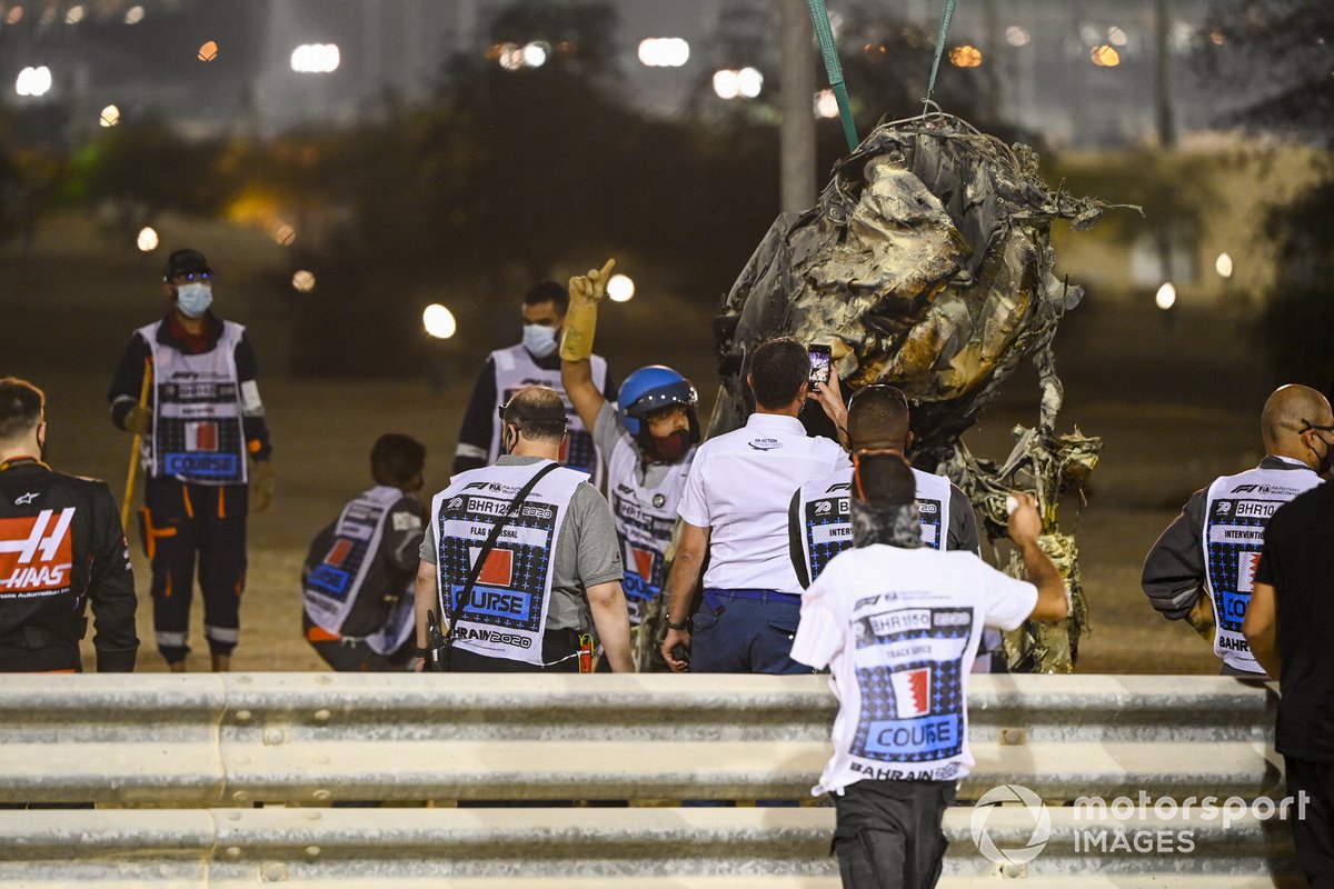 Marshals remove the wreckage after a huge crash for Romain Grosjean, Haas VF-20, on the opening lap
