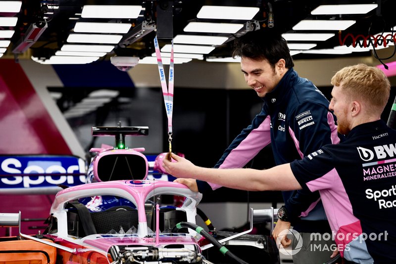 Sergio Perez, Racing Point RP19 looking at a medal above his car