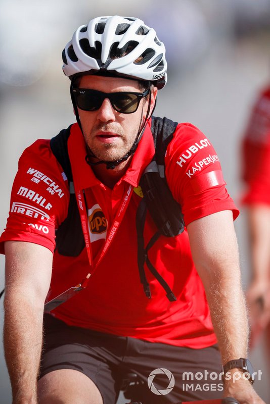 Sebastian Vettel, Ferrari arrives in the paddock on a bike