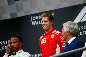 Lewis Hamilton, Mercedes AMG F1, 2nd position, and Sebastian Vettel, Ferrari, 1st position, on the podium