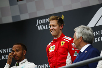 Lewis Hamilton, Mercedes AMG F1, 2nd position, and Sebastian Vettel, Ferrari, 1st position, on the podium