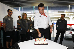 Eric Boullier, Racing Director, McLaren, cuts his birthday cake as Fernando Alonso, McLaren, watches