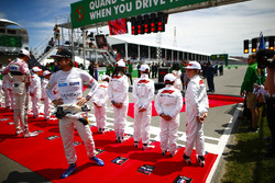 Esteban Ocon, Force India, and Fernando Alonso, McLaren, say hello to the Grid Kid mascots