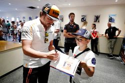 Fernando Alonso, McLaren, signs autographs for the grid kids