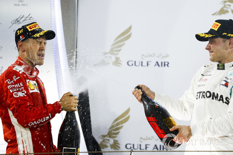 Sebastian Vettel, Ferrari, 1st position, and Valtteri Bottas, Mercedes AMG F1, 2nd position, spray Waard, a non-alcoholic Champagne Rose Water substitute, on the podium