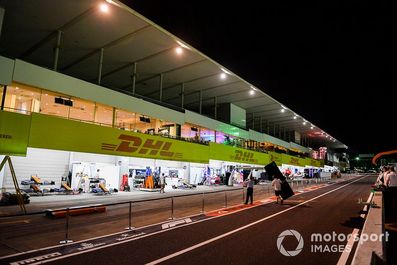 McLaren team members dismantle the pit wall in preparation for the impending Typhoon Hagibis