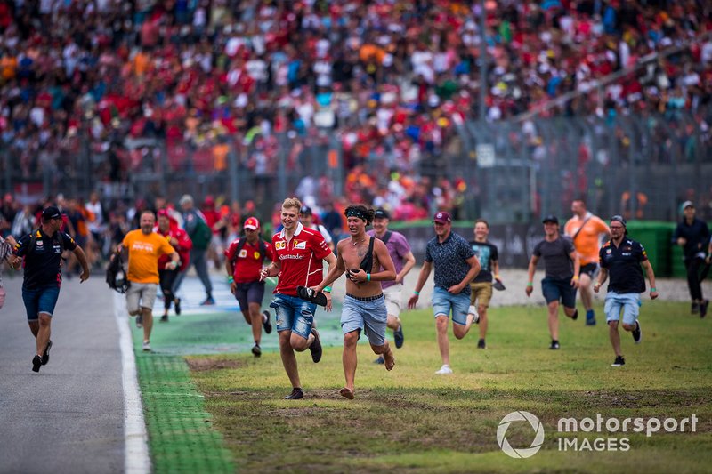 Fans invade the circuit to celebrate at the end of the race