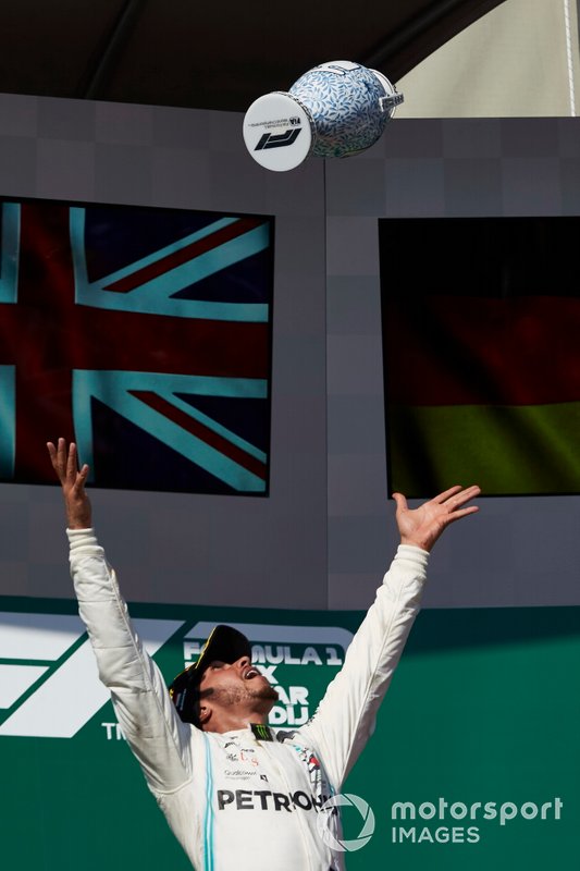Lewis Hamilton, Mercedes AMG F1, 1st position, throws his trophy in the air in celebration