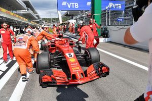 Sebastian Vettel, Ferrari pushes his car back in the pit lane