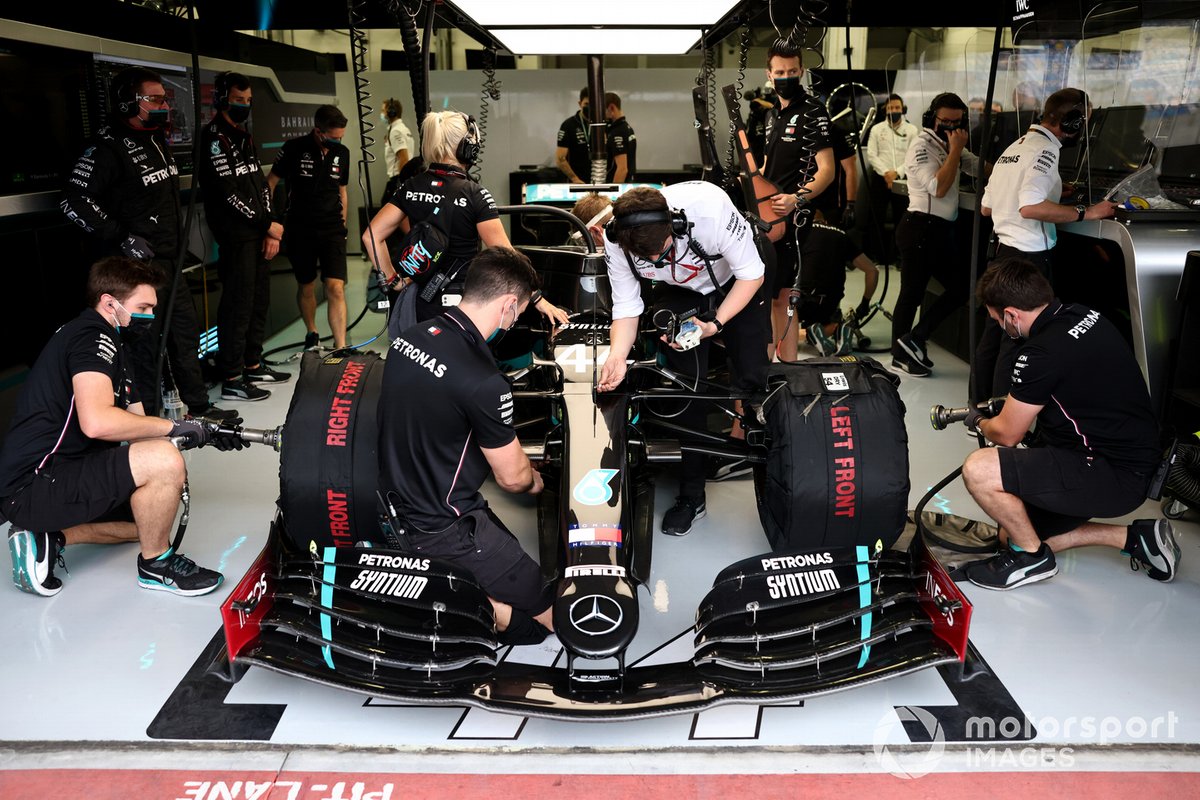 Mechanics work on the car of Lewis Hamilton, Mercedes F1 W11, in the garage