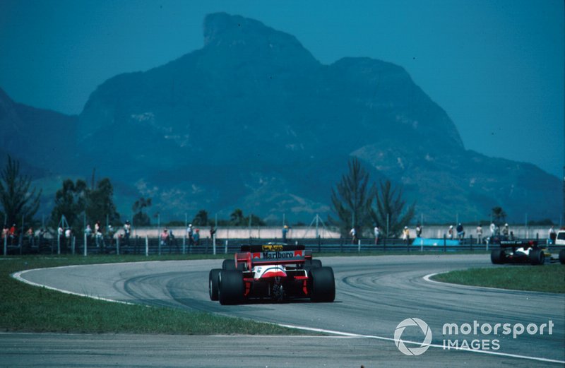 A Ferrari is chased hard by the McLaren.