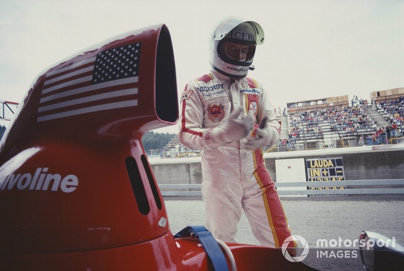 Mario Andretti stands next to his Parnelli VPJ4B Ford in the pits