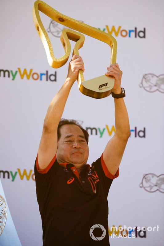 Masashi Yamamoto, General Manager, Honda Motorsport on the podium with the trophy
