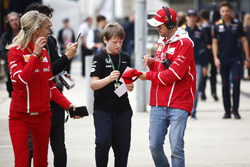 Sebastian Vettel, Ferrari, signs an autograph for a young fan