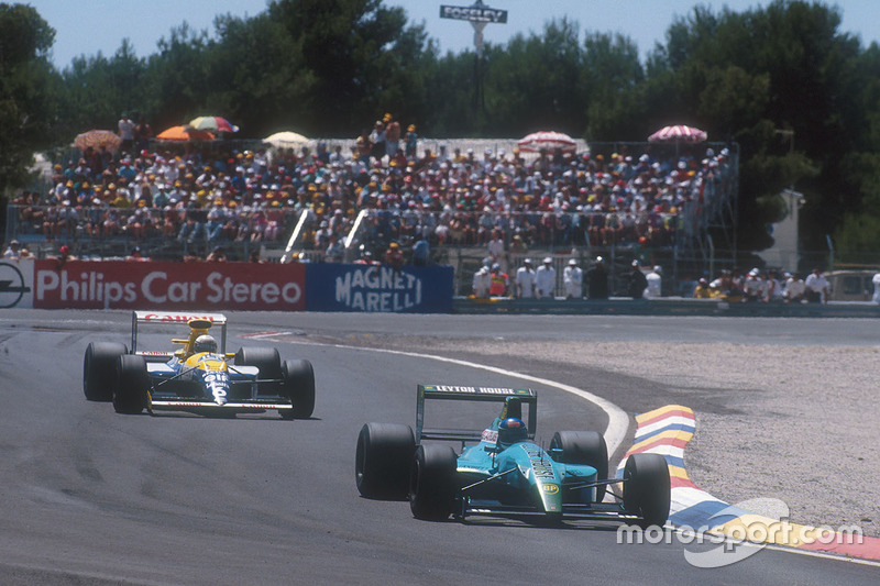 Ivan Capelli, Leyton House CG901 Judd prend la tête de la course pour la première fois, avec Riccardo Patrese, Williams FW13B Renault deuxième derrière lui.