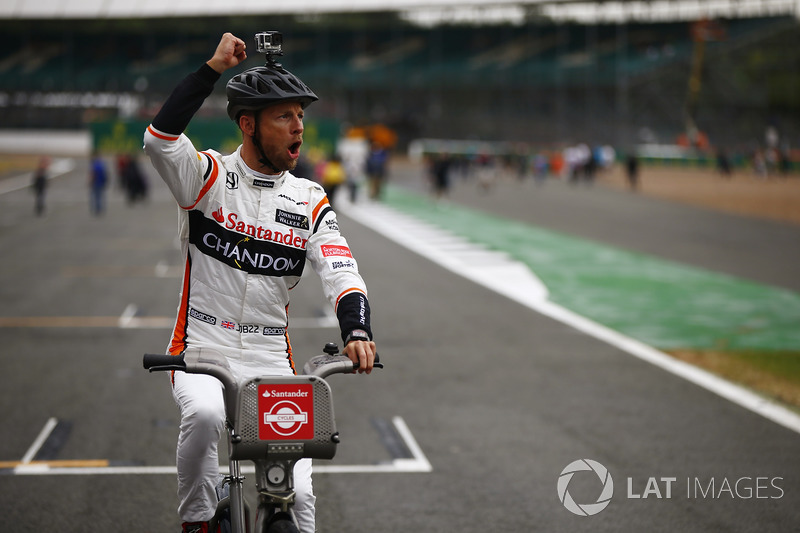 Jenson Button, McLaren, gets in the spirit of a bicycle-related promotional event