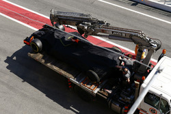 The McLaren MCL32 of Stoffel Vandoorne is returned to the pit lane on the back of a truck