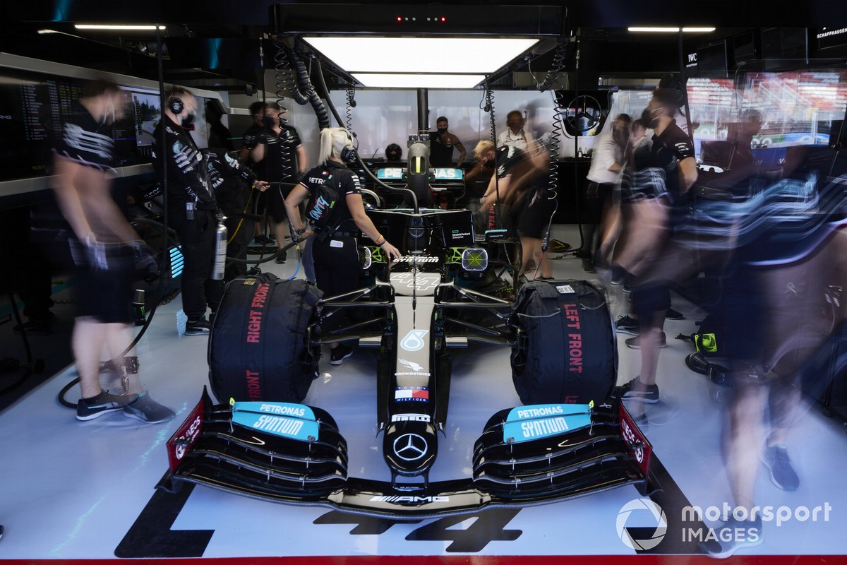 The Lewis Hamilton Mercedes W12 is worked on in the pit garage
