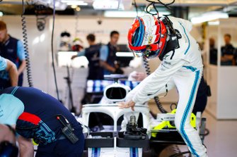 Robert Kubica, Williams Martini Racing, enters his cockpit in the team's garage