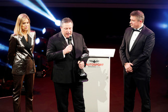 Zak Brown returns to the stage to present a Gregor Grant Award to Stephane Ratel