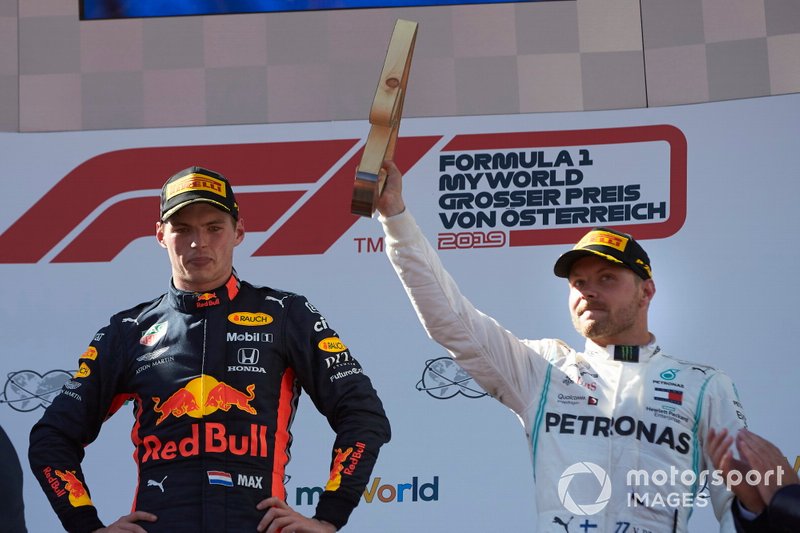 Race winner Max Verstappen, Red Bull Racing, and Valtteri Bottas, Mercedes AMG F1, 3rd position, with his trophy