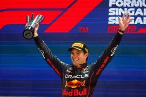 Sergio Perez, Red Bull Racing, 1st position, celebrates on the podium with his trophy