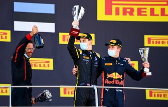 Christian Lundgaard, ART Grand Prix, 1st position, and Juri Vips, Dams, 3rd position, on the podium with their trophies