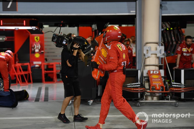 A Ferrari pit crew member with the damaged nose of the car from Sebastian Vettel, Ferrari SF90